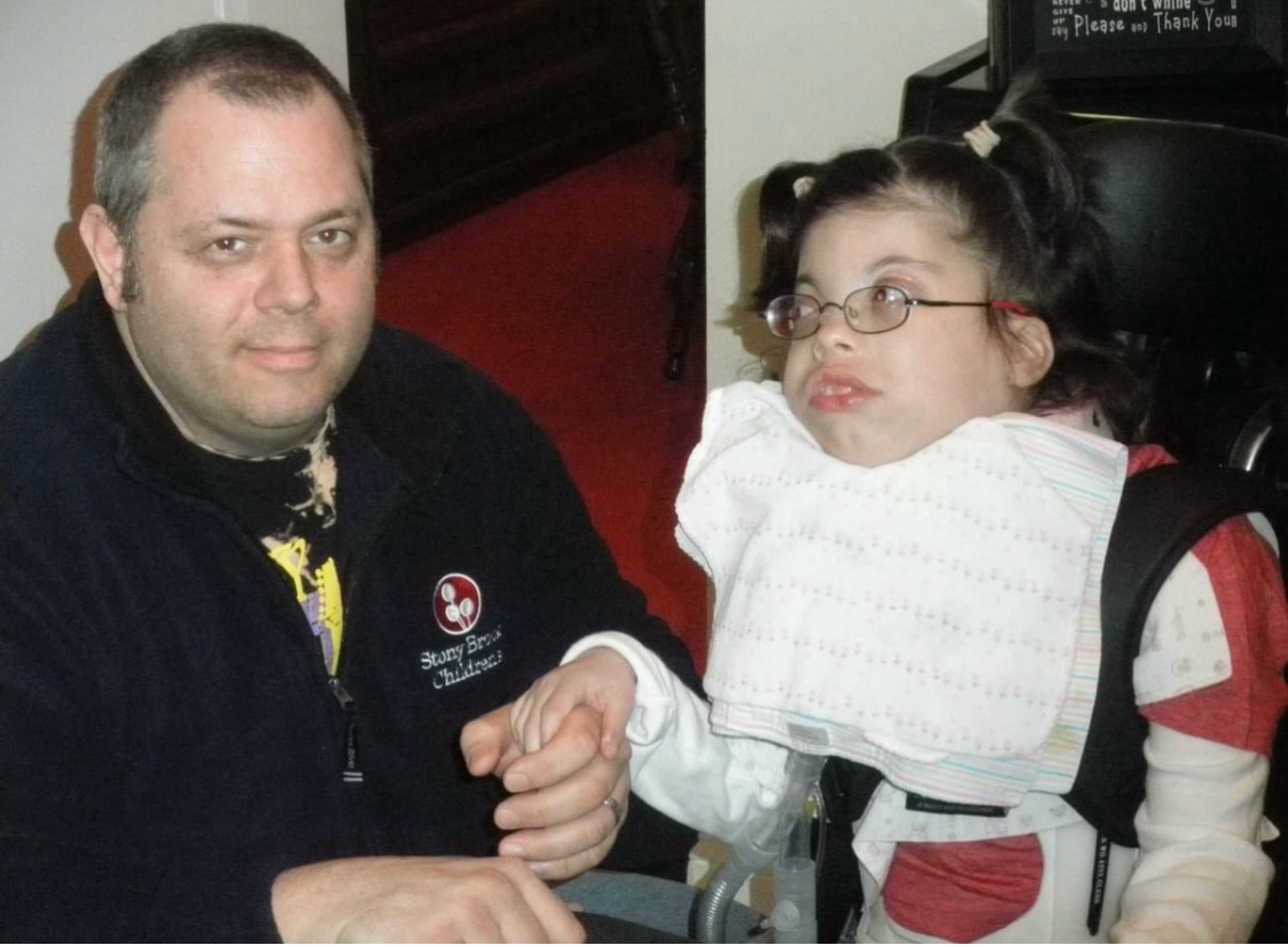 Man and girl holding hands indoors