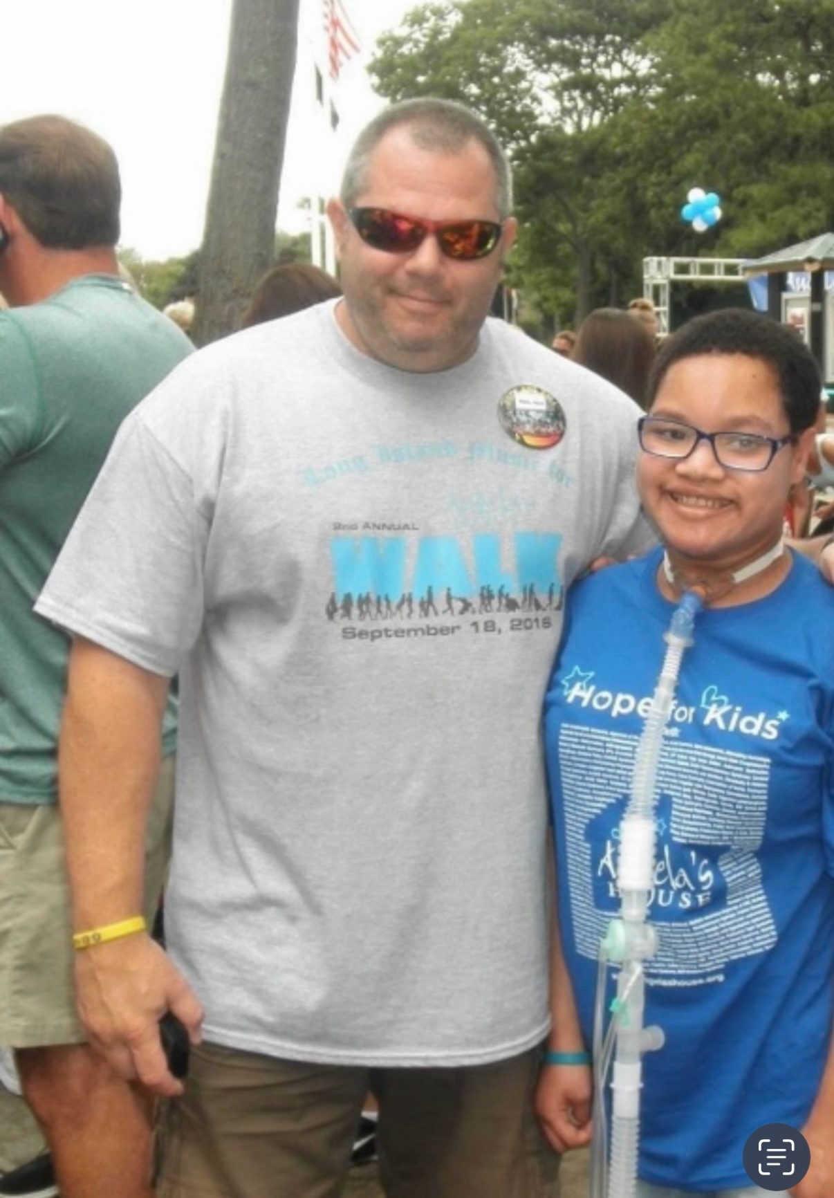 Man and child at outdoor charity event