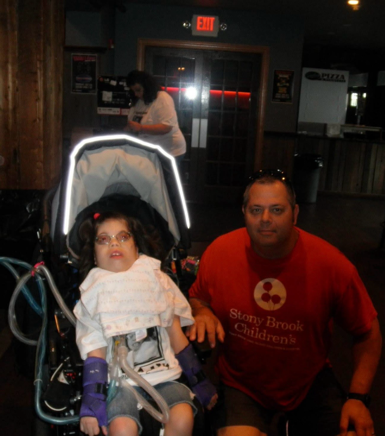 Man and child in stroller at night venue