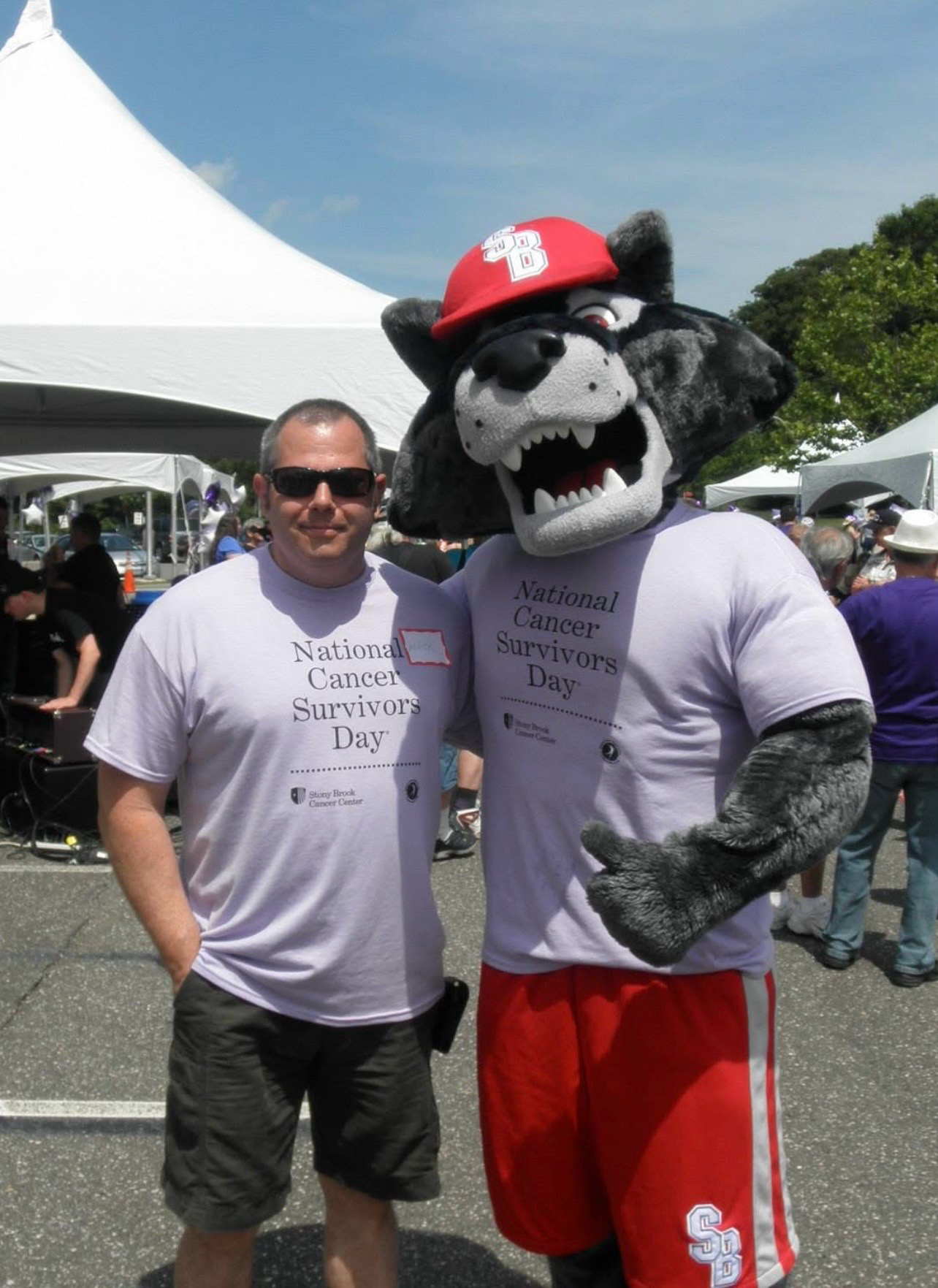 Two men with Stony Brook mascot at National Cancer Survivors Day